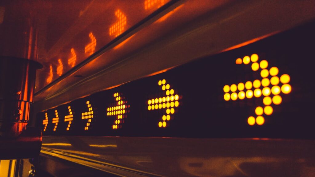 pexels photo 394377 A series of glowing arrow signs in a city environment, indicating direction at night.